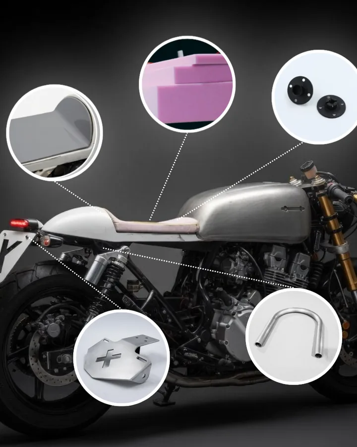 Grey cafe racer motorcycle with callouts for the seat, number plate and tail parts Cafe Racer Garage sells